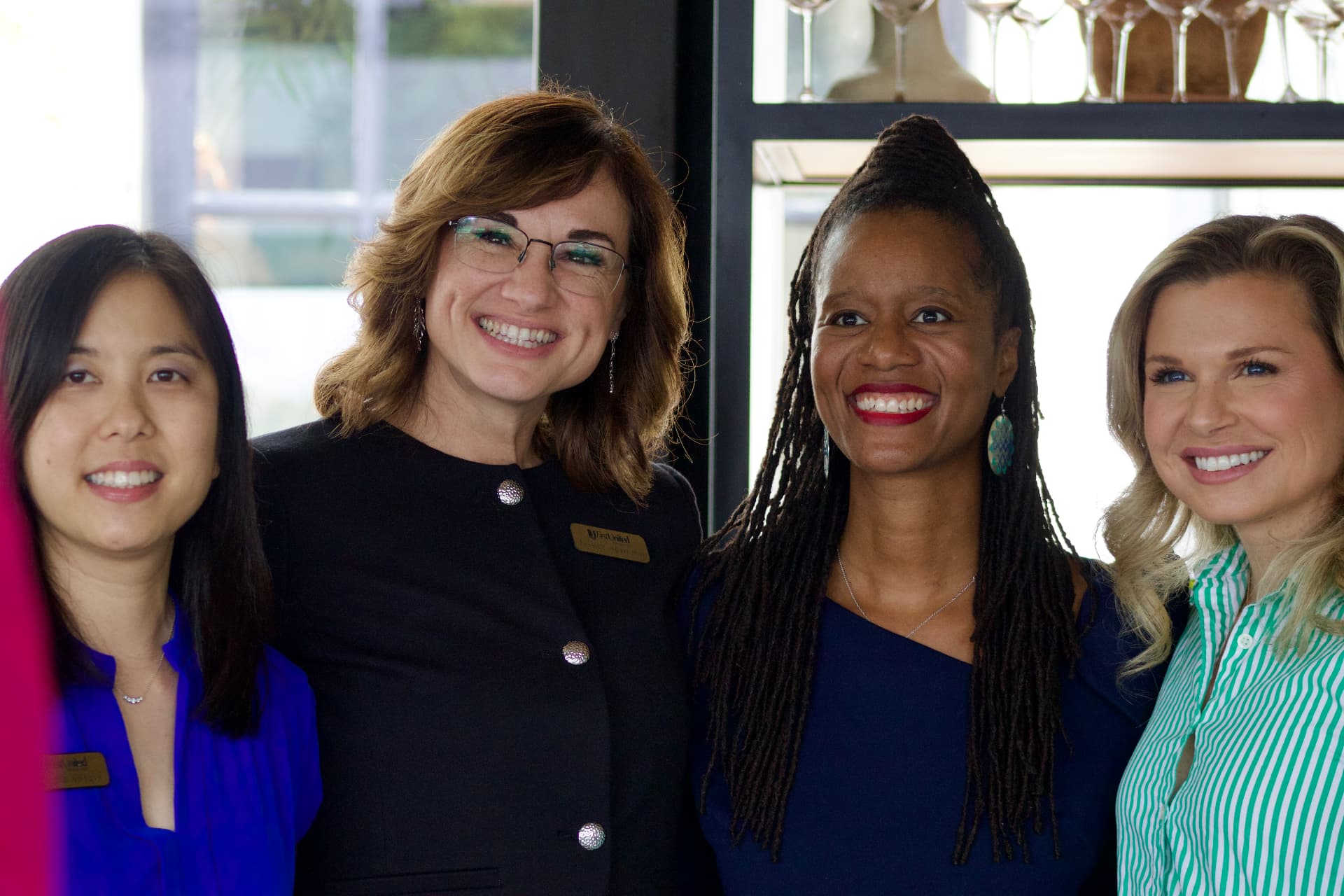 Four guests smiling together at the CEOMOM Power Luncheon